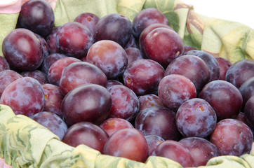 Fresh ripe blue plums in a basket