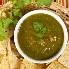 Fresh Homemade Salsa Verde with tortilla chips isolated