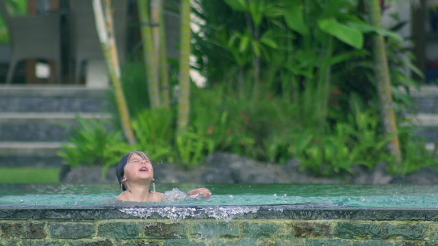 Boy coming out from water in the pool, slow motion 240fps