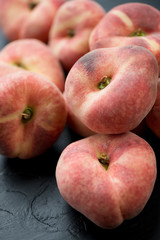 Close-up of ripe saturn peaches, vertical shot