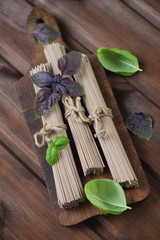 Buckwheat soba noodles, rustic wooden surface, high angle view