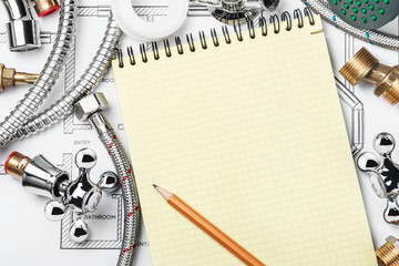 plumbing and tools with a notebook