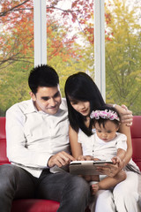 Attractive family with digital tablet at home