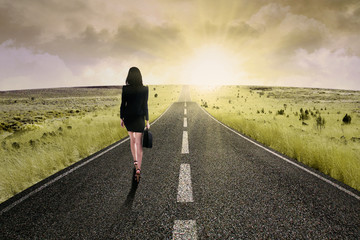 Businesswoman standing on the highway road 2