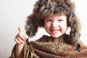 smiling child in fur Hat.fashion winter style.little funny boy