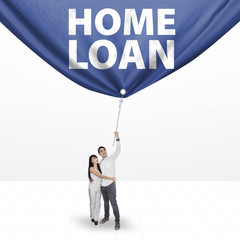 Couple pulling a home loan banner