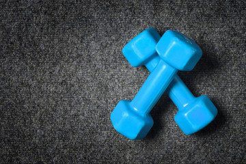 Small dumbbells on floor - fitness concept.