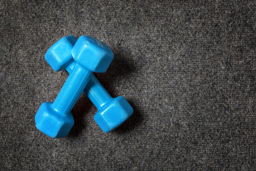 Small dumbbells on floor - fitness concept.