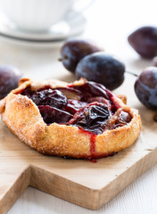 Homemade plum galette on wooden board