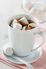 Cup of hot chocolate  with marshmallow on a white table