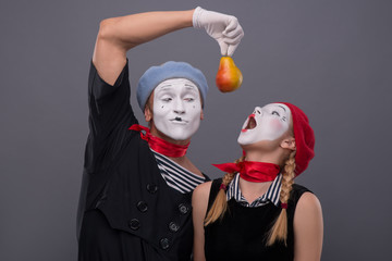 Portrait of funny mime couple with white faces and emotions isol