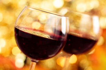 Fresh wine against autumnal lights background.