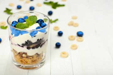 Natural yogurt with fresh berries on wooden table