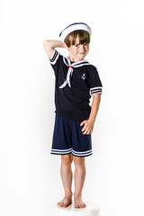 Cute little boy dressed in sailor suit