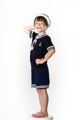 Cute little boy dressed in sailor suit
