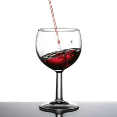 Red wine pouring, slanted horizon, perspective effect.