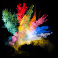 Obraz na płótnie Canvas launched colorful powder over black