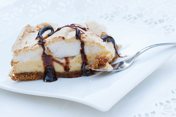 A piece of meringue cake on white background