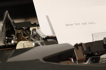 Text Dear Mom and Dad typed on old typewriter