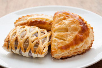 homemade fresh fruit pies on white dish