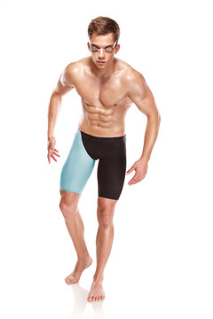 Young attractive caucasian man swimmer with goggles and towel