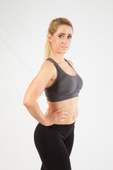 Blond woman in exercise outfit, looking at the camera