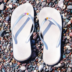 flip-flops on a pebble beach background