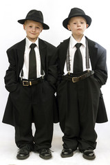 Twin boys dressed as gangsters or Blues Brothers.