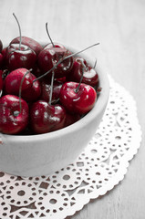 Fresh cherries in bowl on table