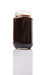 Bottled blueberry jam over white background