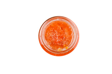 Orange fruit jam in a bottle over white background