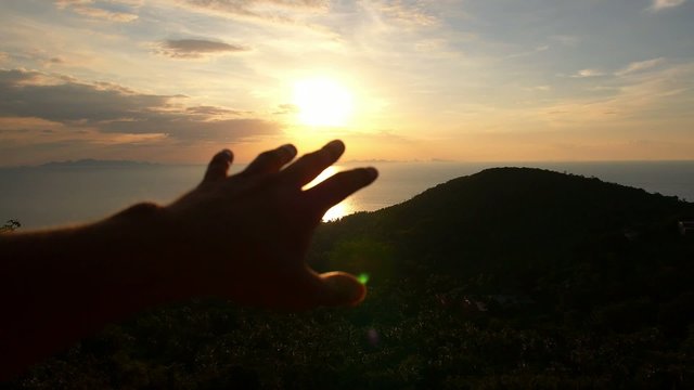 Hand Towards the Sun. Freedom and Happiness at Sunset. Slow