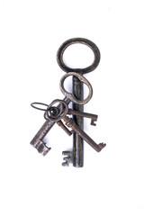 A bunch of old metal keys on a white background isolated