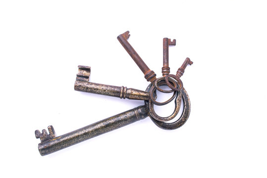 A bunch of old metal keys on a white background isolated