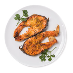 Baked trout steak isolated on white background top view