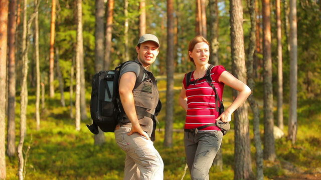 Young tourists couple in forest.