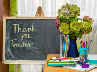 Teacher  Day. Hydrangea flowers and copybooks on the teacher d