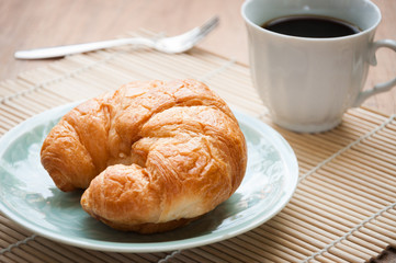 breakfast with croissants, cup of black coffee