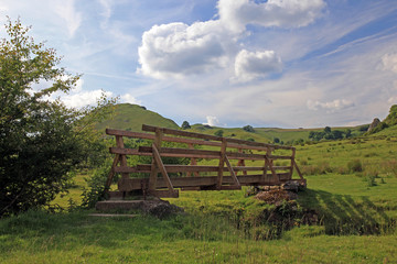 wooden bridge over a river in the Peak District National Park.