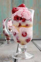 Raspberry layer dessert on wooden background, copy space