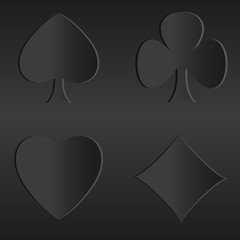 Obraz premium Black suits of cards unusual black background