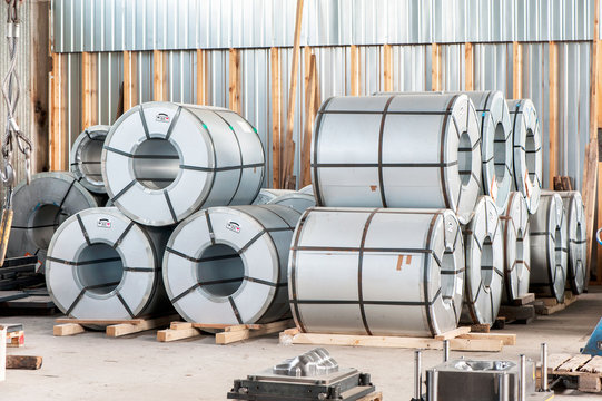 Bended steel/metal sheet rolls in factory warehouse/workshop.