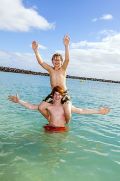 boys having fun in the clear sea