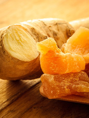 Closeup root and candied ginger on wooden table