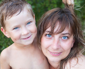 Woman with her young son after bathing in the river.