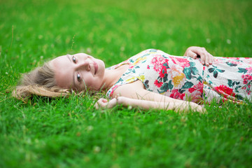 Beautiful young girl lying on the grass