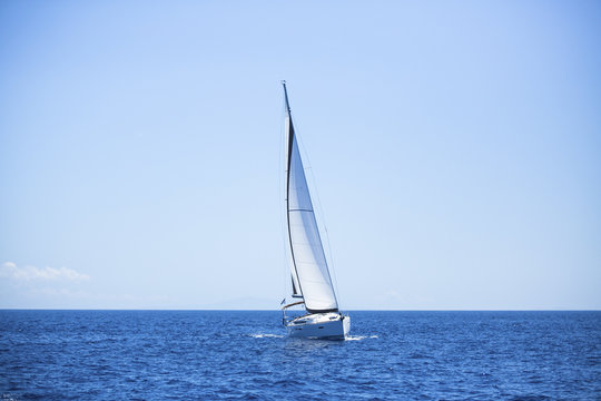 Fototapeta Lonely sailboat in the open sea. Romantic trip.