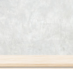 Empty wooden table over cement wall.