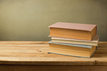 Vintage books in pastel color on wooden table with copy space