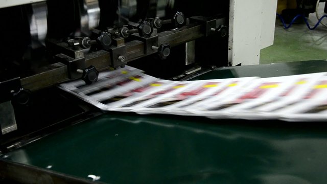 finished brochure magazine goes on the packaging line